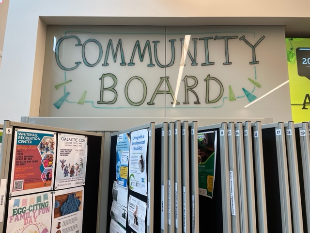 Sign in building says community board written in marker.